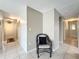 Hallway with tile floors, neutral walls, and an accent chair at the intersection at 542 Cascade Cir # 102, Casselberry, FL 32707