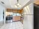Bright kitchen features stainless steel appliances, light wood cabinetry, and tile flooring at 542 Cascade Cir # 102, Casselberry, FL 32707