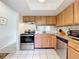 Contemporary kitchen design with stainless appliances, light-wood cabinets, and tile floors at 542 Cascade Cir # 102, Casselberry, FL 32707