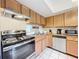 Updated kitchen features stainless steel appliances, tile backsplash, and sleek range hood at 542 Cascade Cir # 102, Casselberry, FL 32707