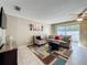 Comfortable living room with a ceiling fan, neutral colors, and sliding glass doors to the outside at 542 Cascade Cir # 102, Casselberry, FL 32707