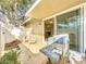 Cozy patio area with seating and grill, adjacent to sliding glass doors leading to the dining room at 542 Cascade Cir # 102, Casselberry, FL 32707