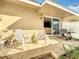 A quaint patio with chairs, a grill, and sliding glass doors to the interior living space at 542 Cascade Cir # 102, Casselberry, FL 32707