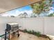 Outdoor patio featuring a grill, white fence, and some foliage along the fence at 542 Cascade Cir # 102, Casselberry, FL 32707