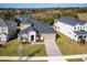 Aerial view of a two-story house with a landscaped yard and paver driveway at 686 Creeping Fig St, Apopka, FL 32703