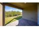 Covered patio overlooking fenced backyard with nature views at 686 Creeping Fig St, Apopka, FL 32703