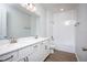 Bathroom with double vanity, white cabinets, and a bathtub at 686 Creeping Fig St, Apopka, FL 32703