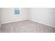 Bright bedroom with a large window and gray carpeting at 686 Creeping Fig St, Apopka, FL 32703