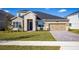 Two-story house with stone accents and landscaping at 686 Creeping Fig St, Apopka, FL 32703