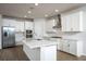 Modern kitchen with white cabinets and stainless steel appliances at 686 Creeping Fig St, Apopka, FL 32703
