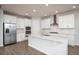 Modern kitchen with white cabinets, stainless steel appliances, and an island at 686 Creeping Fig St, Apopka, FL 32703