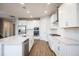 Modern kitchen with white cabinets and stainless steel appliances at 686 Creeping Fig St, Apopka, FL 32703