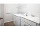 Bright laundry room with washer, dryer, and utility sink at 686 Creeping Fig St, Apopka, FL 32703