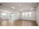 Spacious living area with hardwood floors and sliding glass doors at 686 Creeping Fig St, Apopka, FL 32703