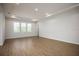 Bright and spacious living room with wood-look flooring and recessed lighting at 686 Creeping Fig St, Apopka, FL 32703