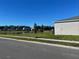 Scenic view featuring a tranquil pond and well-maintained green space behind the property at 247 Villavista Ct, Davenport, FL 33896