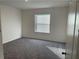 This bedroom features plush carpet, neutral walls, a window for natural light, and ample space at 247 Villavista Ct, Davenport, FL 33896
