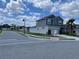 Corner lot home featuring well-manicured landscaping, a two-car garage, and an inviting exterior design at 247 Villavista Ct, Davenport, FL 33896