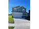 Attractive two-story home displaying a manicured lawn, a convenient two-car garage, and a welcoming facade at 247 Villavista Ct, Davenport, FL 33896