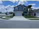 Charming two-story home showcasing a well-maintained lawn, a driveway, and a neatly attached two-car garage at 247 Villavista Ct, Davenport, FL 33896