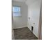 This laundry room features modern wood-look tile, utility connections, and a window for natural light at 247 Villavista Ct, Davenport, FL 33896