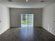 Bright, open room featuring tiled flooring, large windows to outside view and neutral-colored walls at 247 Villavista Ct, Davenport, FL 33896