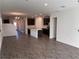 Open-concept living space showcasing tile floors, a modern kitchen, and ample natural light at 247 Villavista Ct, Davenport, FL 33896