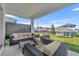 Covered back patio features outdoor seating with views of the lawn at 4473 Davos Dr, Clermont, FL 34711
