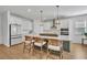 Modern kitchen with white cabinets, stainless steel appliances, and a large island with bar seating at 4473 Davos Dr, Clermont, FL 34711