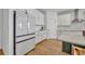 Well-lit kitchen with stainless steel appliances, white cabinetry, and an island with countertop seating at 4473 Davos Dr, Clermont, FL 34711