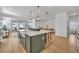 Open-concept kitchen with large island, hardwood floors, and seamless flow into the living area at 4473 Davos Dr, Clermont, FL 34711