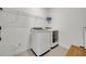 Bright laundry room features a washer, dryer, and built in storage at 4473 Davos Dr, Clermont, FL 34711