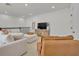 Bright living room features a large sectional sofa, television, and vaulted ceilings at 4473 Davos Dr, Clermont, FL 34711
