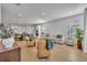 Open-concept living room with hardwood floors connected to the kitchen and featuring neutral décor at 4473 Davos Dr, Clermont, FL 34711