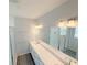 Modern bathroom with double sinks, sleek fixtures, and a glass-enclosed shower for a luxurious feel at 576 Pothos St, Apopka, FL 32703