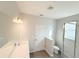 Bright bathroom featuring a large mirror, vanity and glass-enclosed shower with stylish tile work at 576 Pothos St, Apopka, FL 32703