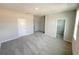 Spacious bedroom with plush gray carpeting, neutral walls, and a walk-in closet ready for personalization at 576 Pothos St, Apopka, FL 32703