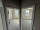 Two bedrooms shown through doorways; each features neutral walls, gray carpet, and natural light from large windows at 576 Pothos St, Apopka, FL 32703
