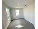 A bright bedroom with tile floors, neutral paint, and two large windows offers ample natural light at 576 Pothos St, Apopka, FL 32703