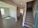 This entryway has tile floors, access to the stairs, and a view into the kitchen area at 576 Pothos St, Apopka, FL 32703