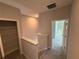 This second story hallway features carpeted floors and access to a storage closet at 576 Pothos St, Apopka, FL 32703
