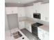 This kitchen features stainless steel appliances, quartz countertops, and a stylish sink and faucet at 576 Pothos St, Apopka, FL 32703