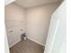 Compact laundry area with tile flooring, shelving and utility connections, ready for appliances at 576 Pothos St, Apopka, FL 32703