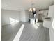 Bright, open-concept living space featuring modern lighting, tile floors and a kitchen with a center island at 576 Pothos St, Apopka, FL 32703