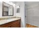 Bathroom featuring granite counters, vanity lighting, and walk in closet with shelving at 9517 Brackin St, Orlando, FL 32825