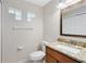 Cozy half bathroom with decorative mirror and granite sink top at 9517 Brackin St, Orlando, FL 32825
