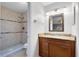 Bathroom featuring a granite vanity, updated fixtures and tiled walk in shower at 9517 Brackin St, Orlando, FL 32825