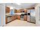 Well-equipped kitchen featuring stainless steel appliances, granite countertops and classic wooden cabinetry at 9517 Brackin St, Orlando, FL 32825