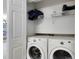 Convenient laundry room with modern washer and dryer, closet, and extra storage space at 9517 Brackin St, Orlando, FL 32825