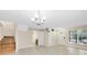 Spacious living room with tile floors, staircase, and convenient access to a half bathroom and entryway at 9517 Brackin St, Orlando, FL 32825
